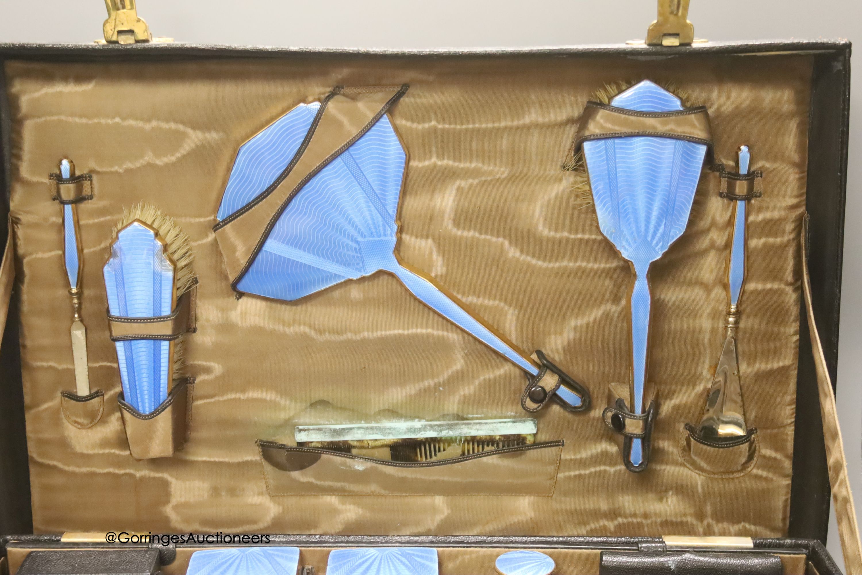 An early 20th century leather vanity case, with enclosed accessories and five further silver mounted vanity bottles